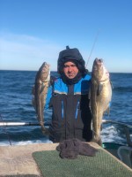 a person holding a fish in the water