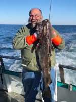 a man holding a fish in the water
