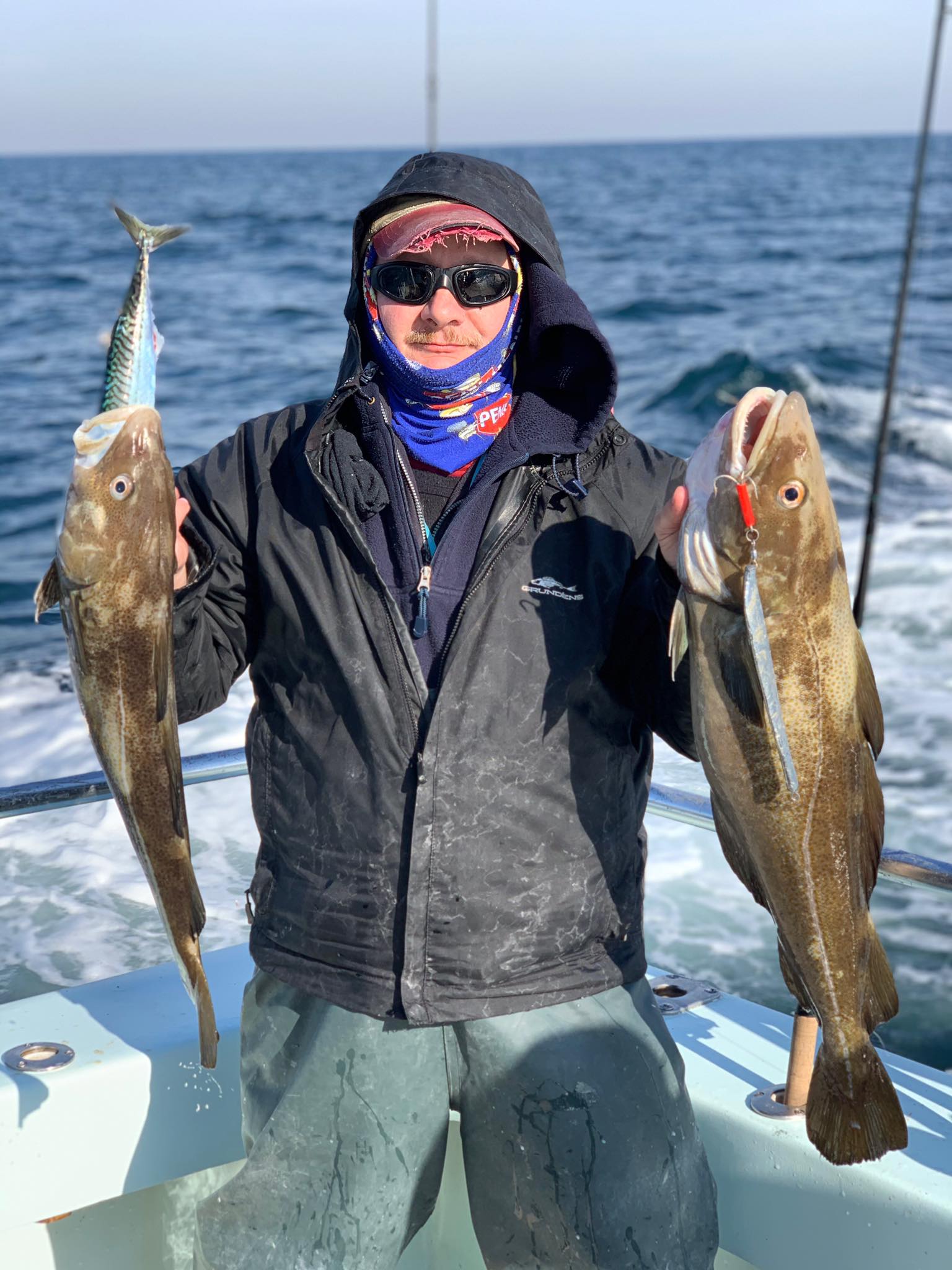a person holding a fish in the water
