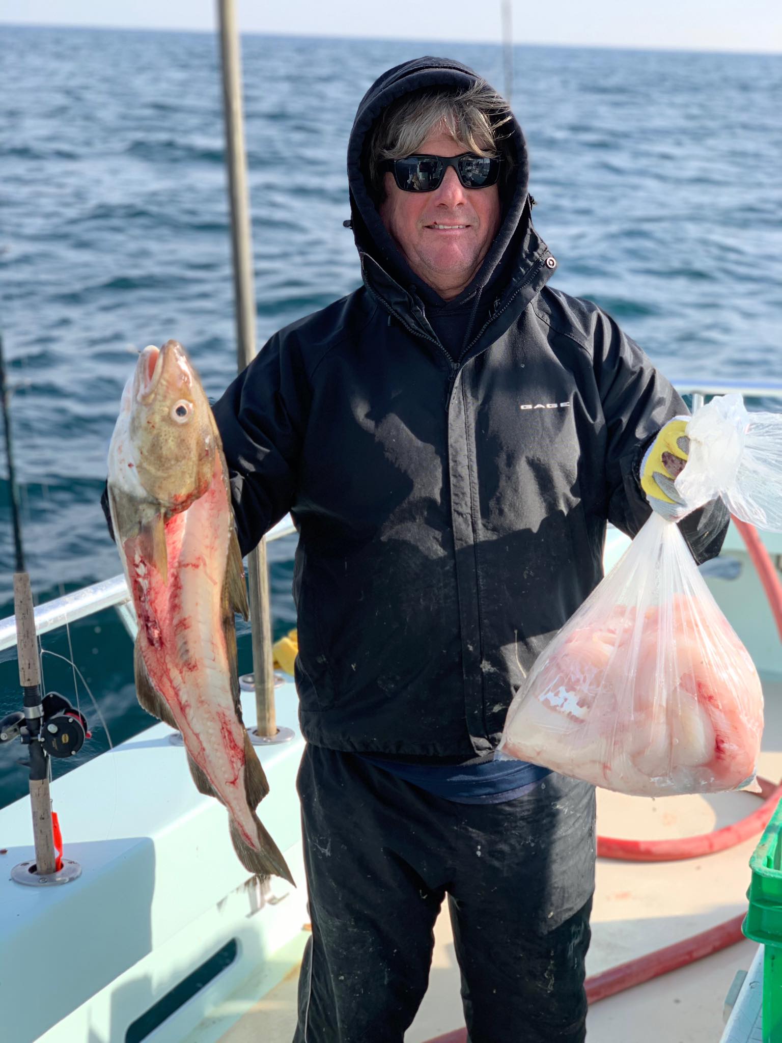 a man holding a fish in the water