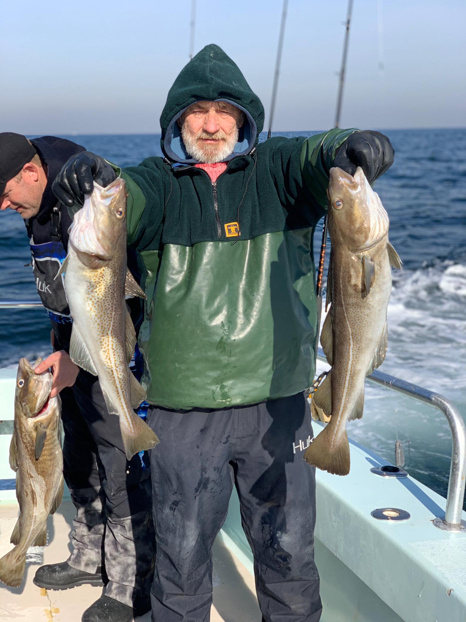 a man holding a fish in the water