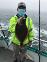 a person holding a fish on a boat in the water