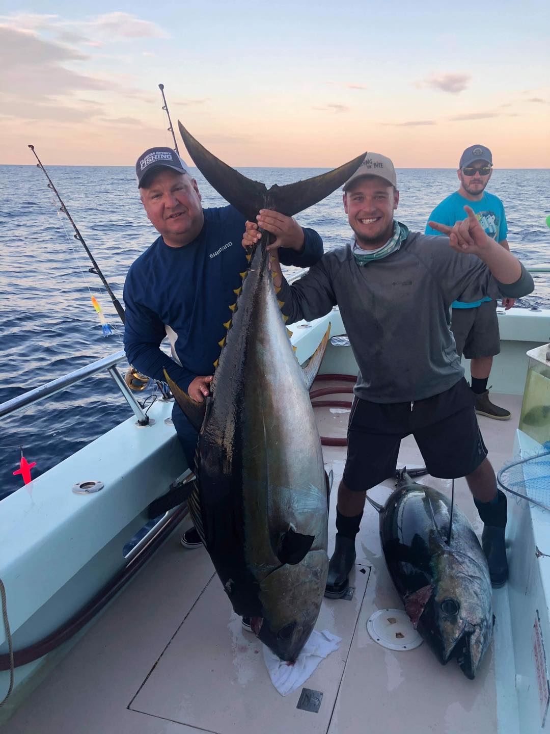 a man holding a fish in the water
