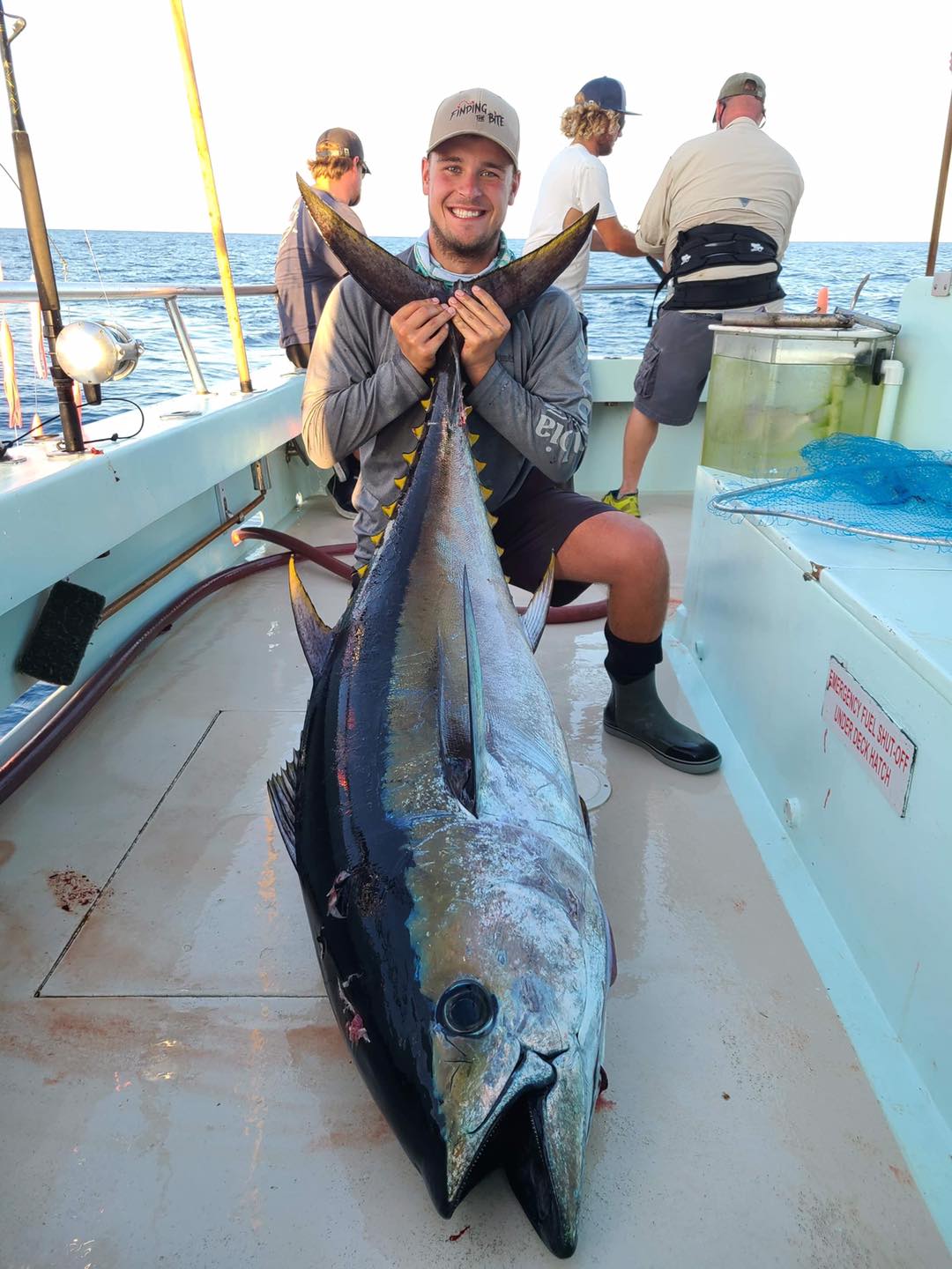 a person holding a fish on a boat