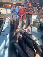 a group of people standing in front of a fish