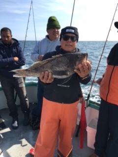 a person holding a fish in the water