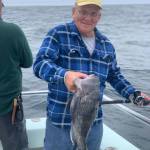 a man holding a fish in the water