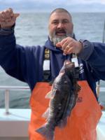 a man holding a fish in the water