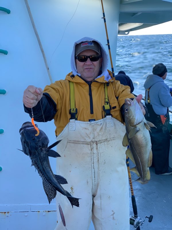 a person holding a fish in the water