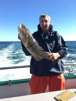 a man holding a fish in the water