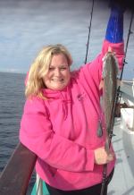 a person holding a fish in the water