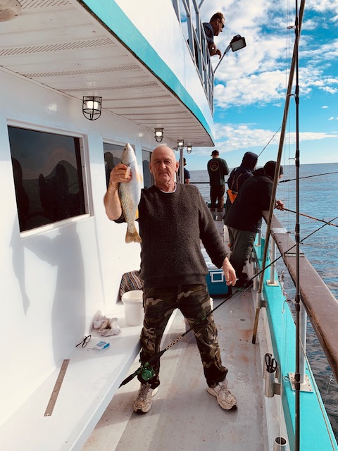 a group of people standing on a boat