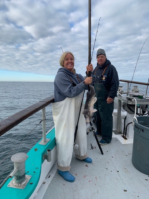 a group of people standing next to a body of water
