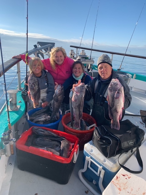 a group of people on a boat posing for the camera