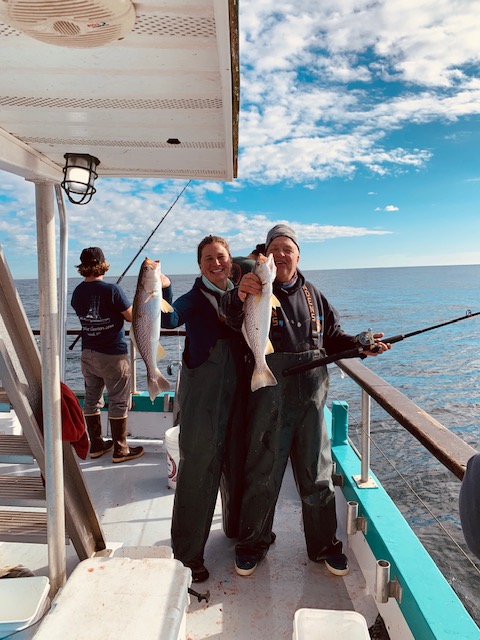 a group of people standing on a boat in the water
