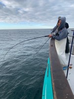 a man standing next to a body of water