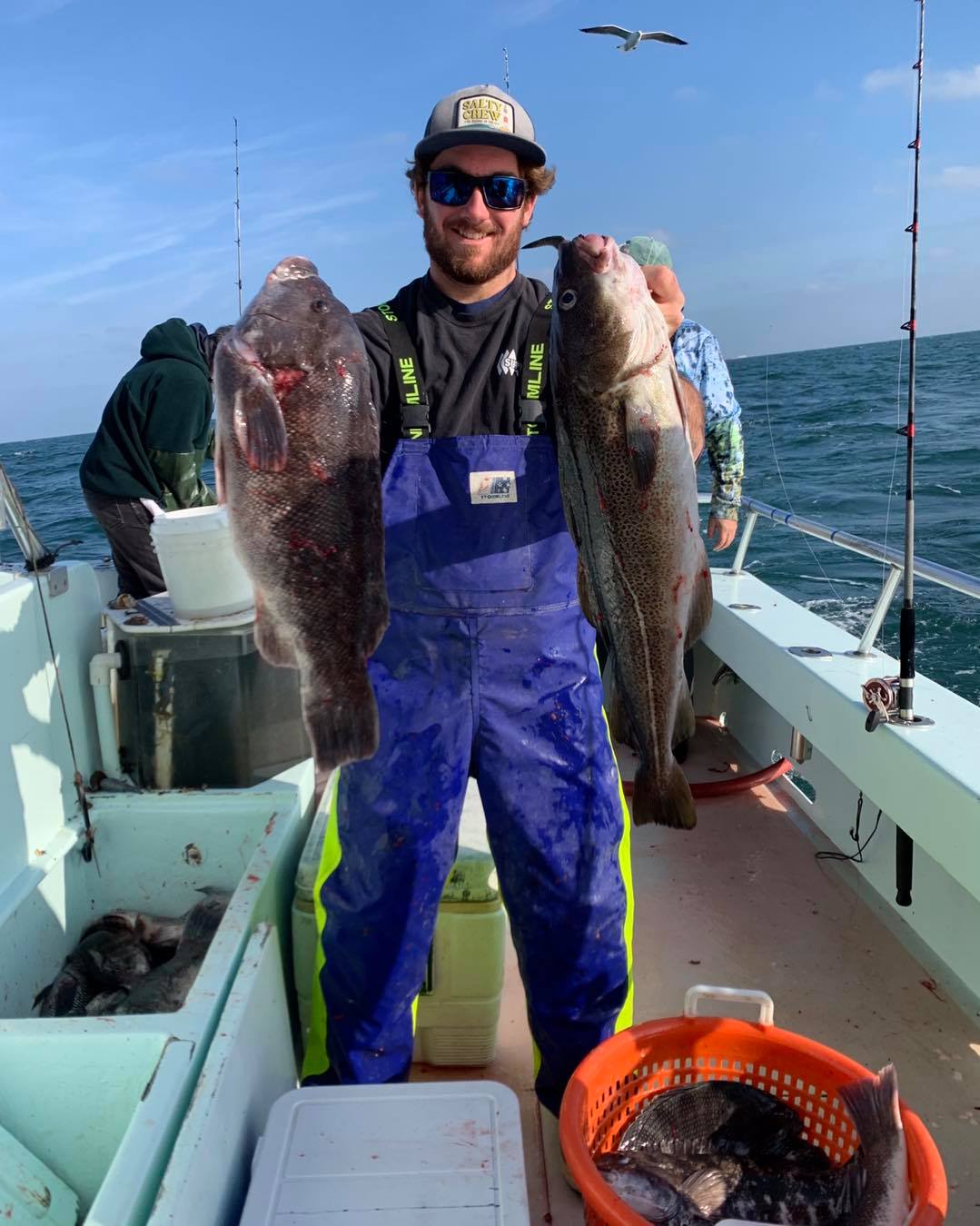 a man holding a fish on a boat