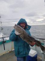 a person holding a fish in the water