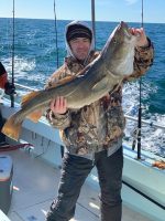 a man holding a fish in the water