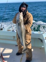 a man holding a fish in the water