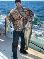 a man holding a fish in the water