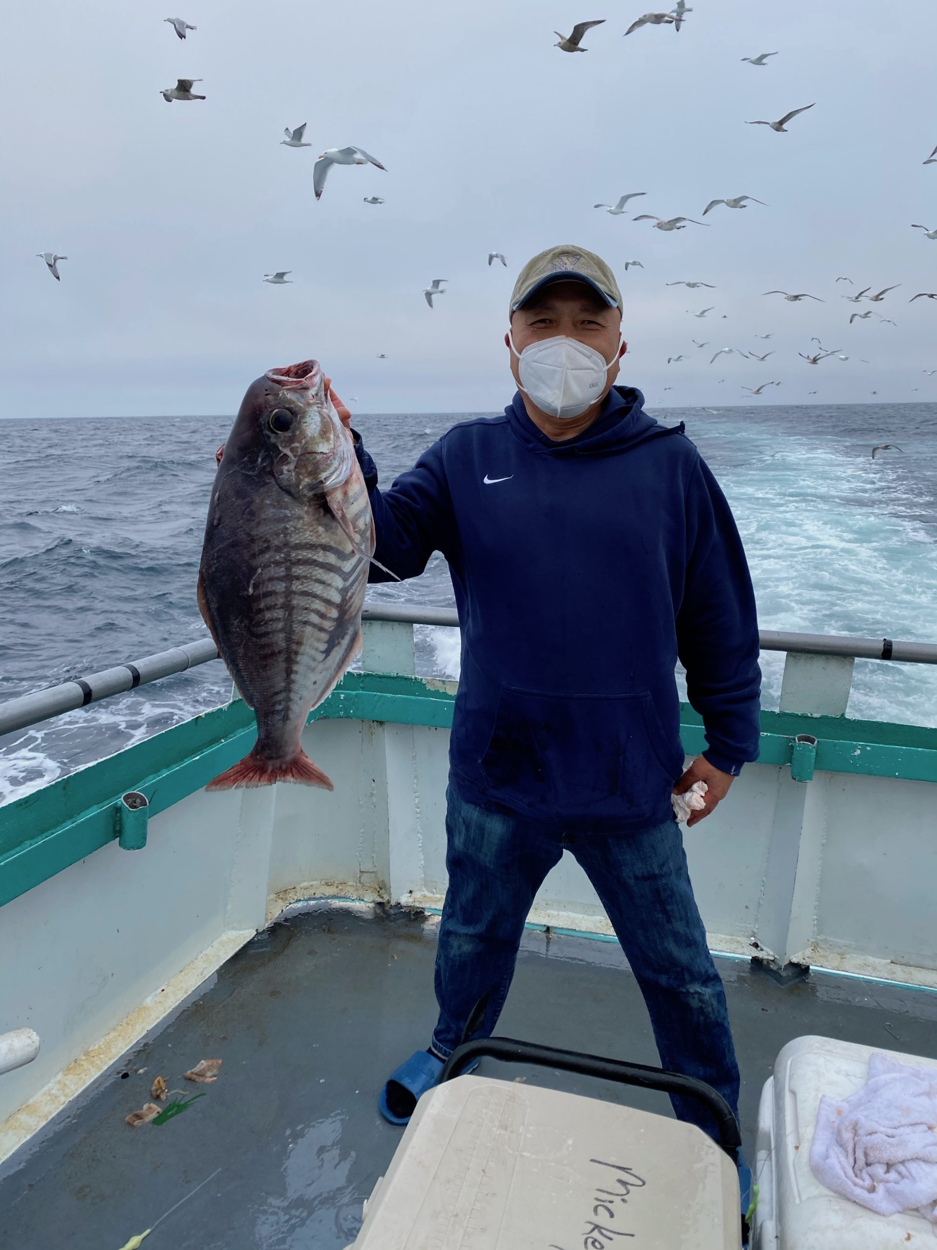 a man holding a fish in the water