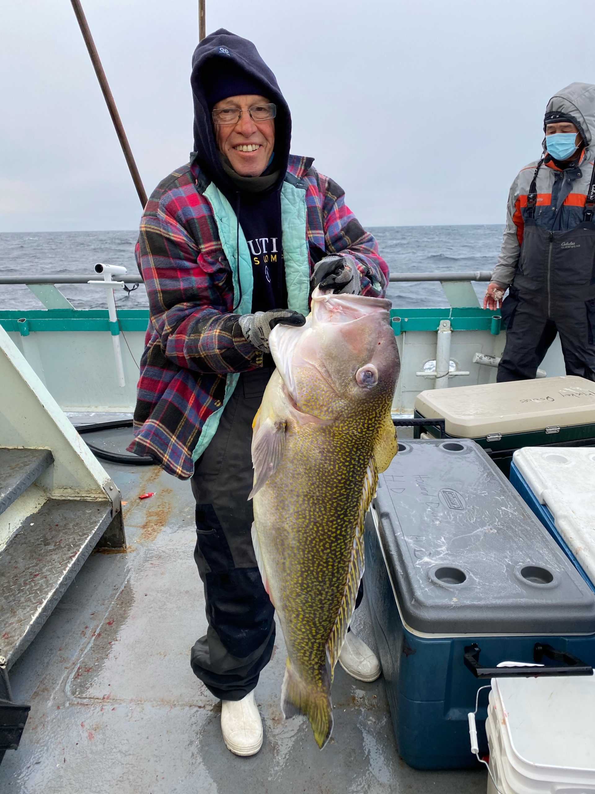 a person holding a fish on a boat