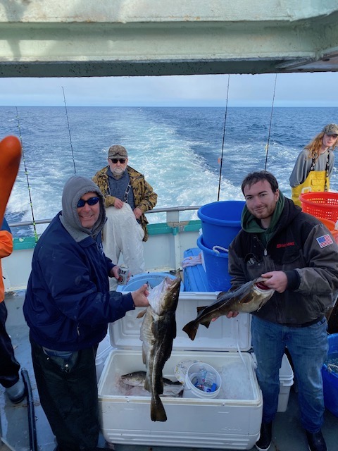 a person holding a fish on a boat in the water