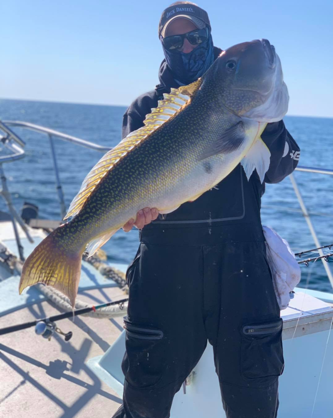 a man holding a fish in the water
