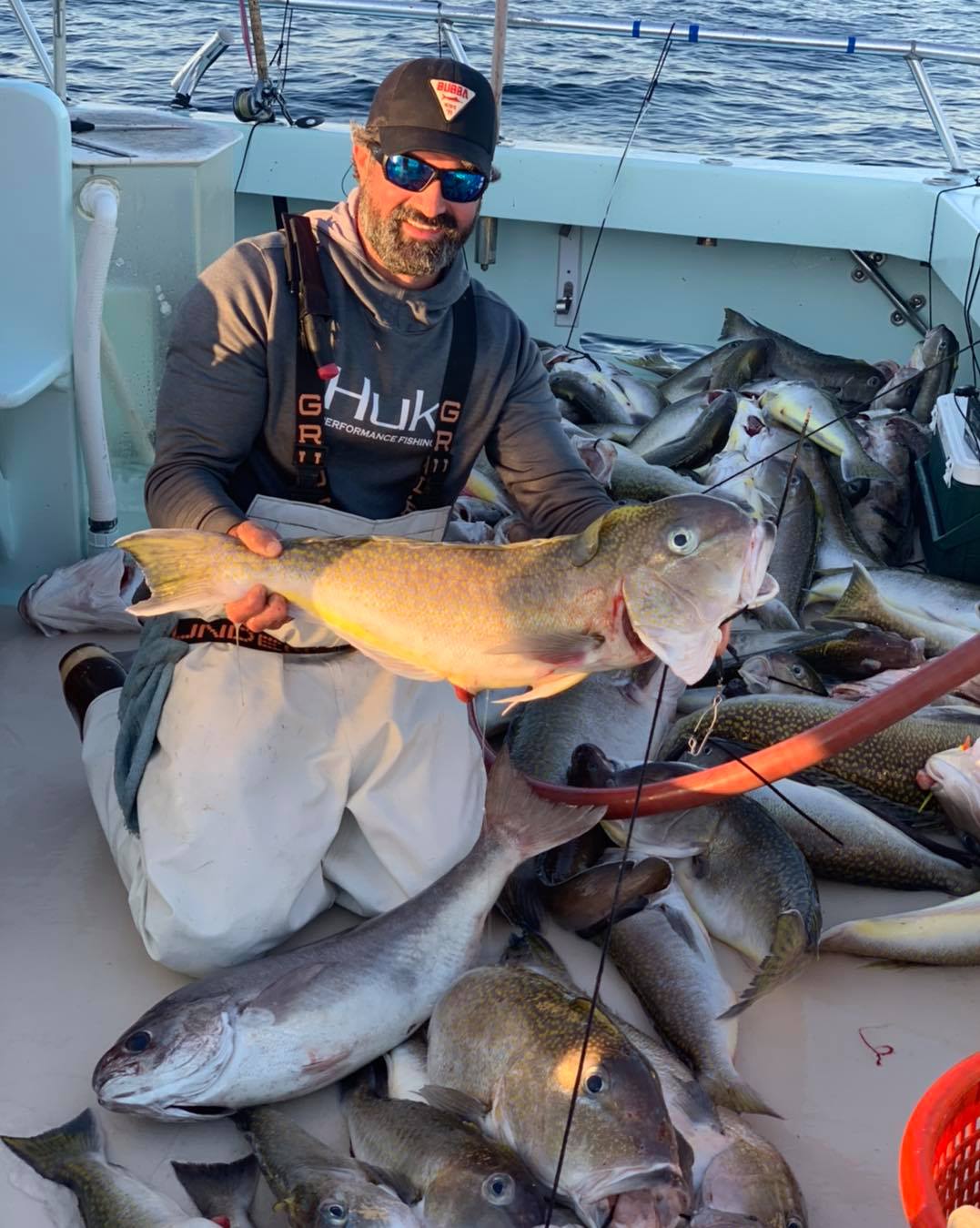 a man holding a fish on a boat