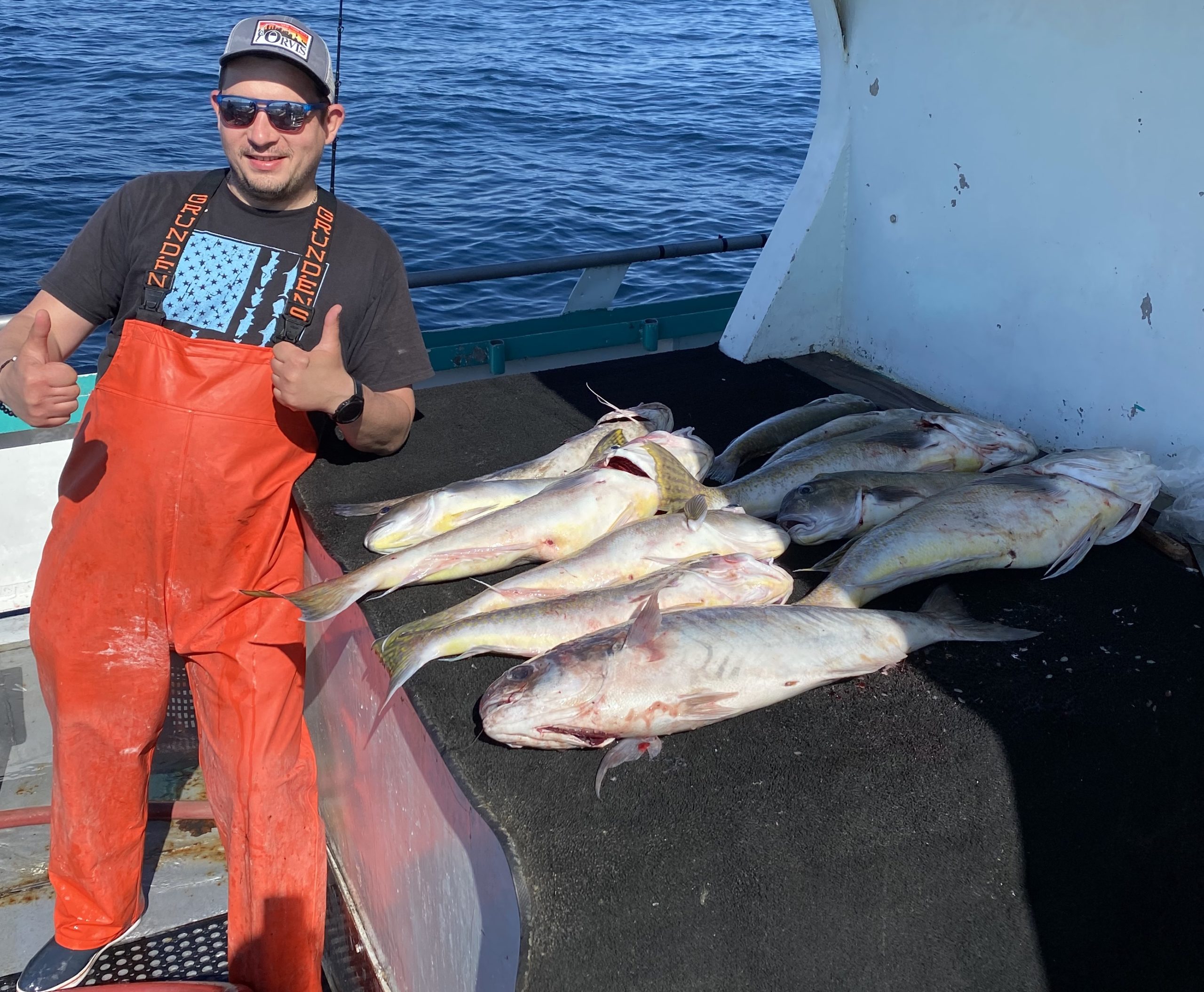 a person holding a fish in the water
