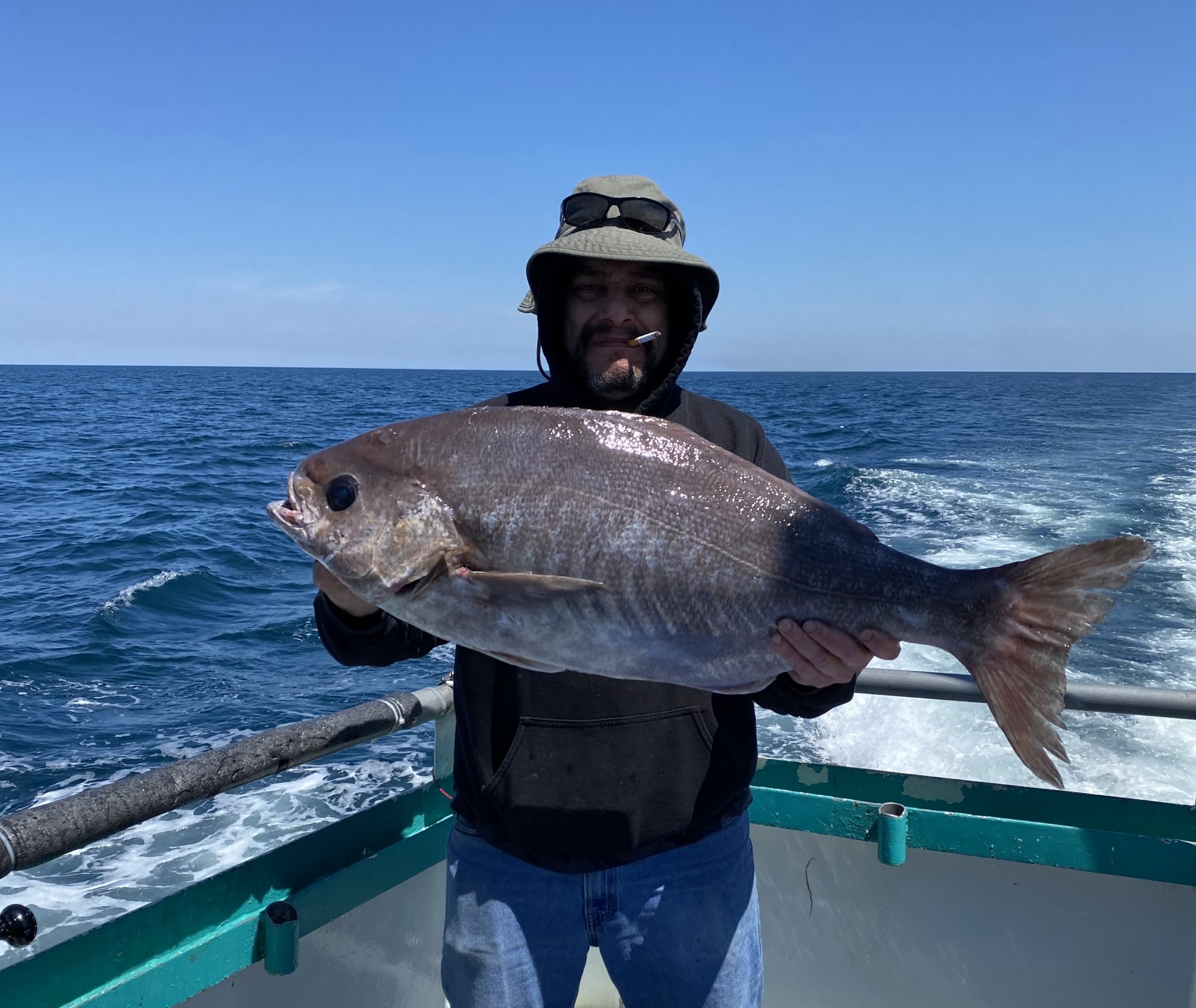 a man holding a fish in the water