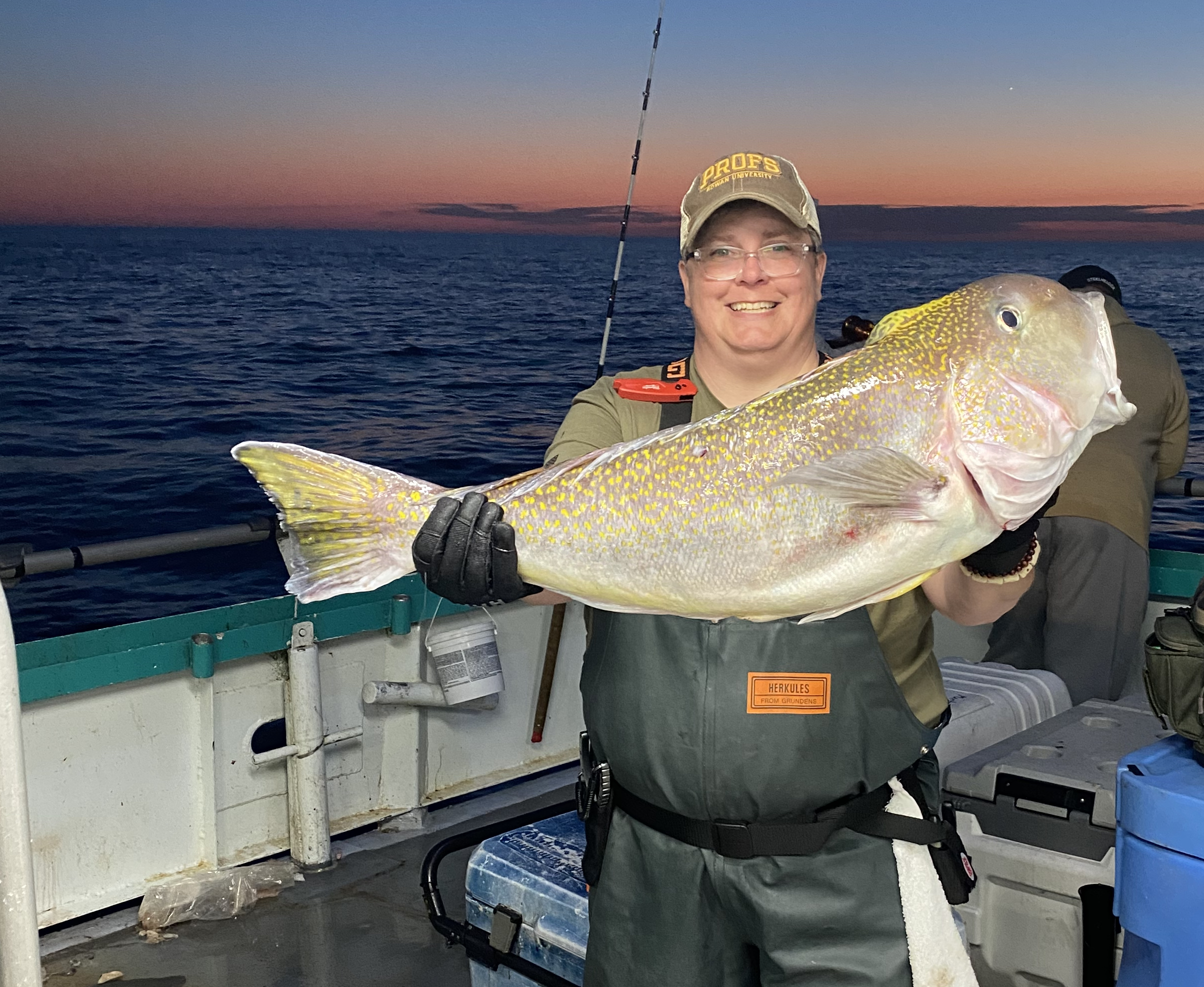 a person holding a fish in the water