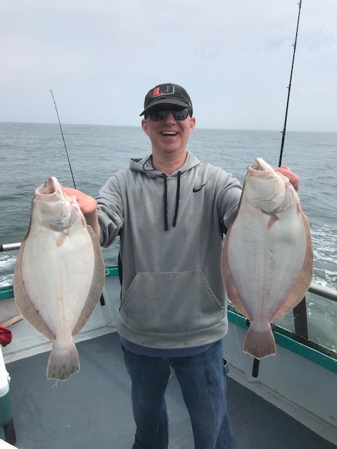 a man holding a fish in the water