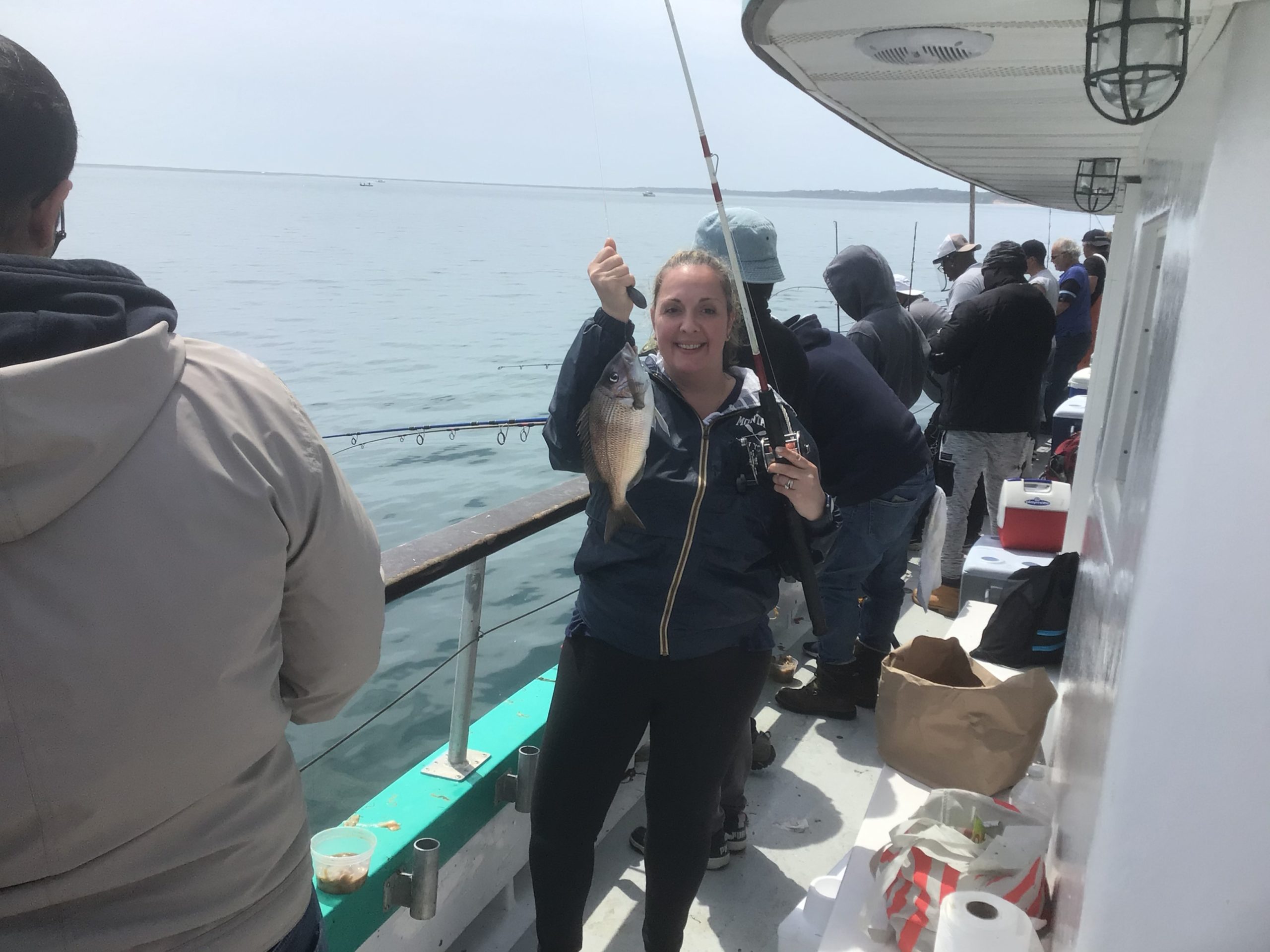 a person holding a fish on a boat in the water