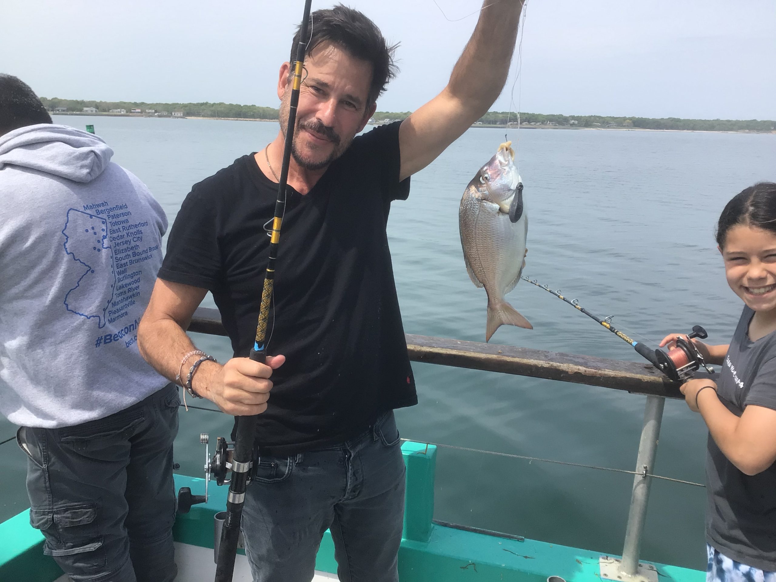 Ricky Paull Goldin holding a fish in the water