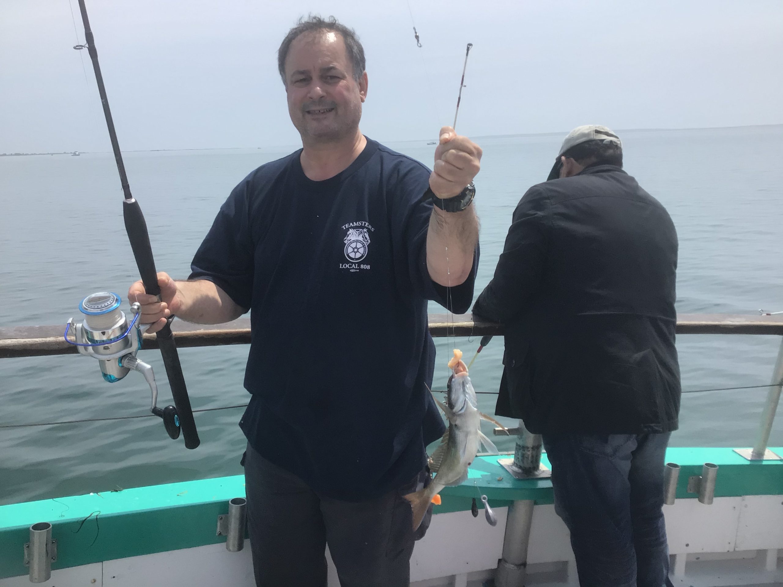 a man holding a fish in the water
