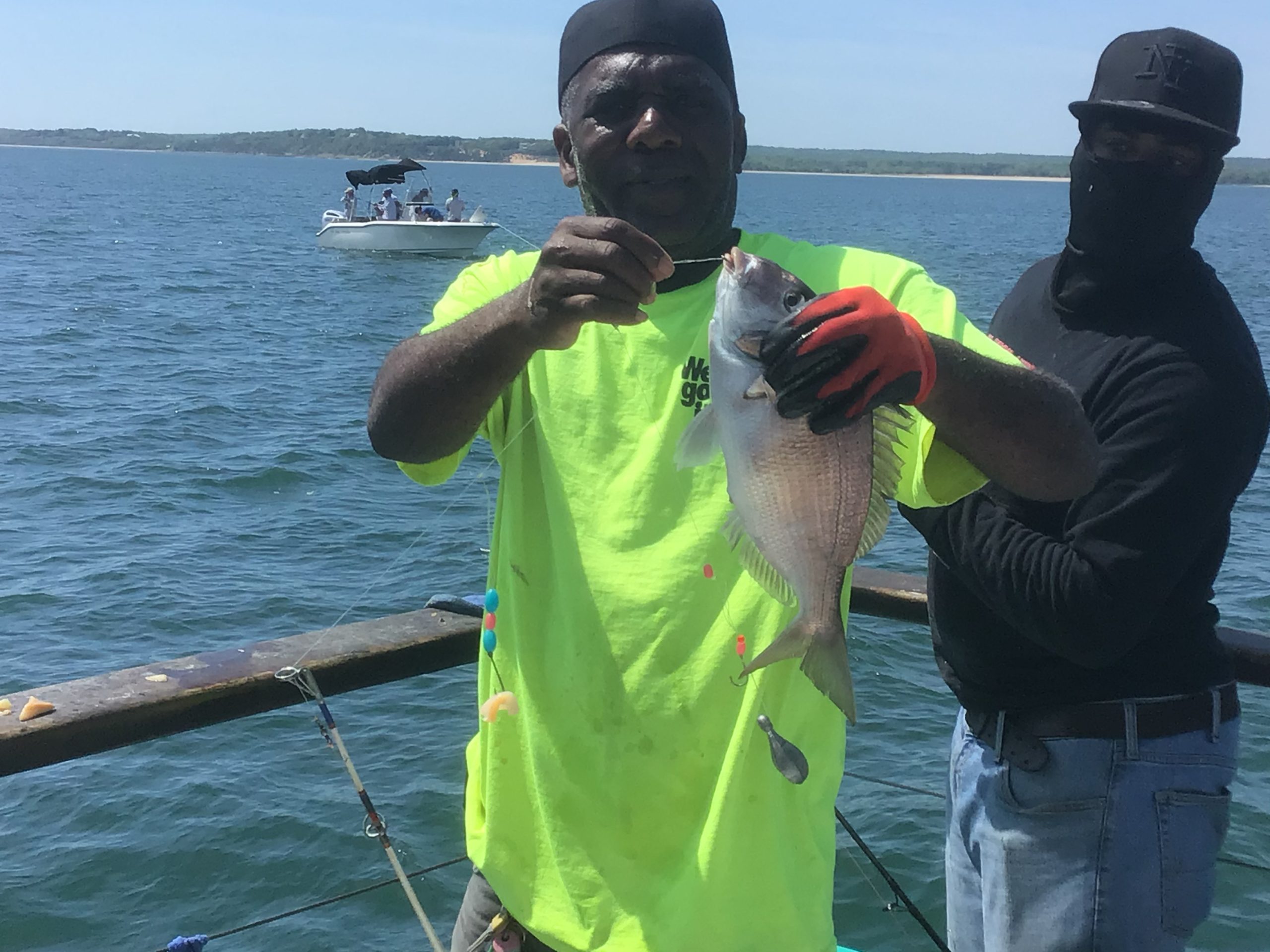 a man holding a fish in the water