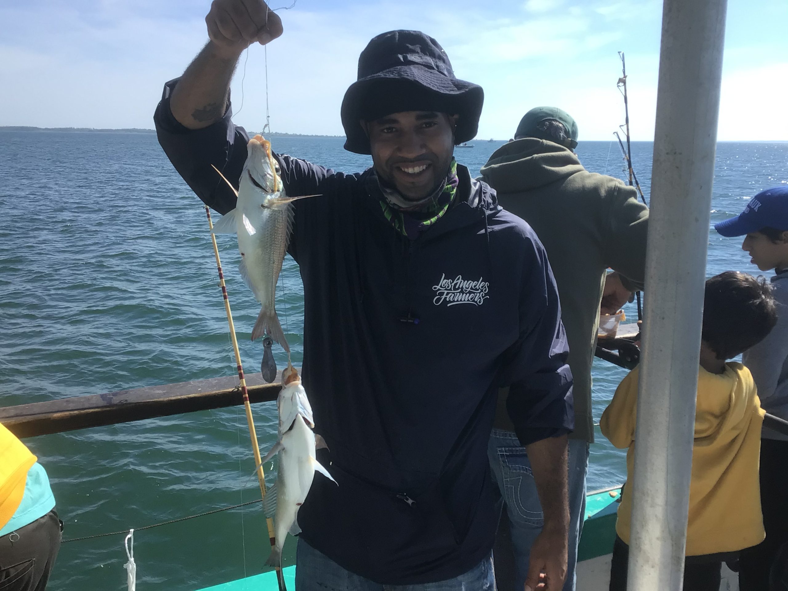a man standing next to a body of water