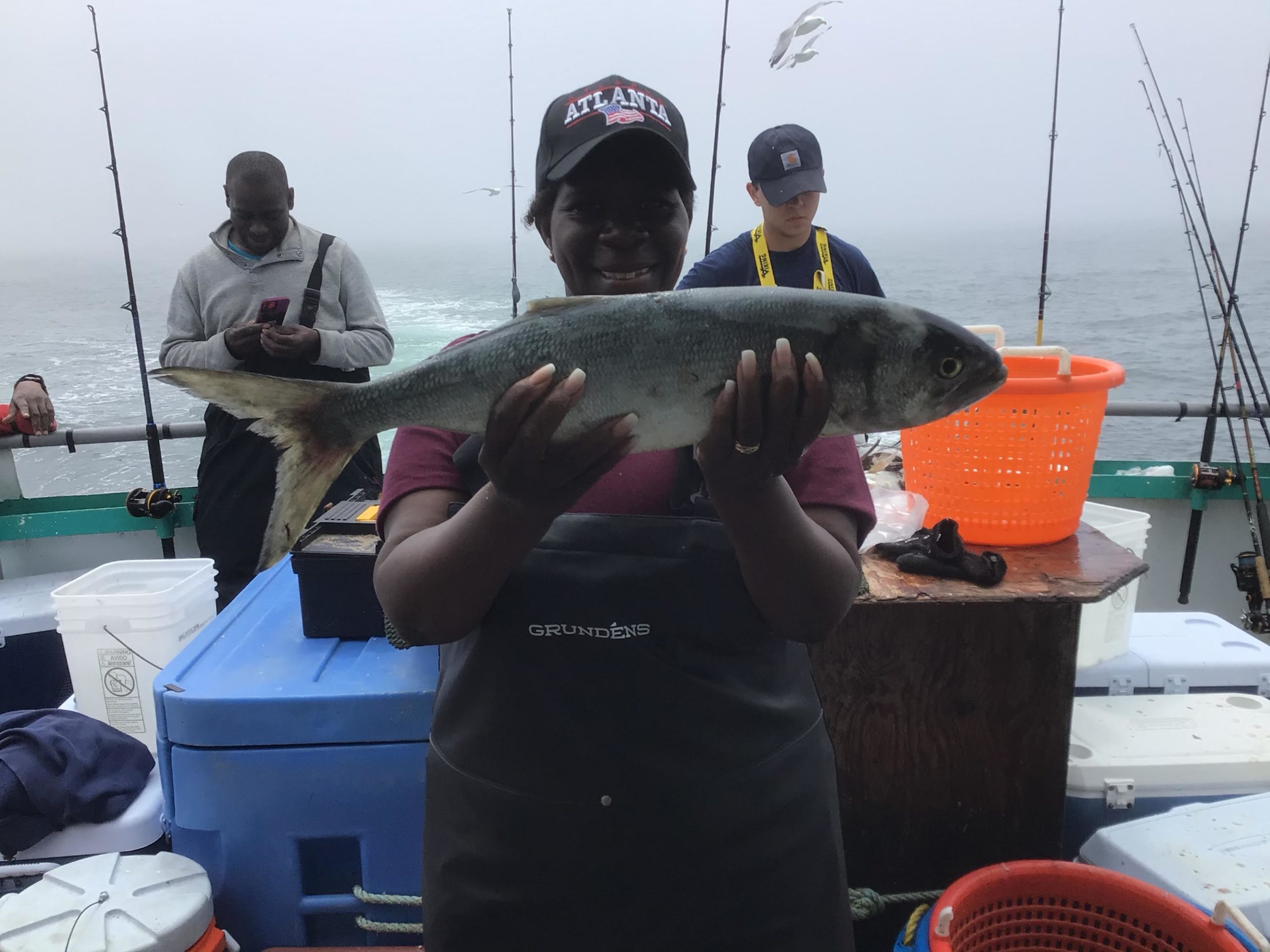 a man holding a fish on a boat