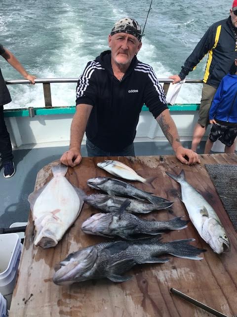 a man holding a fish in the water