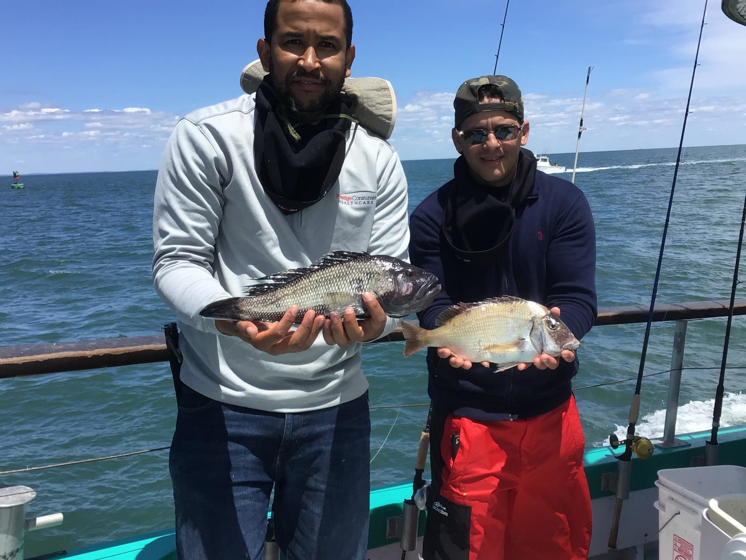 a person holding a fish on a boat in the water