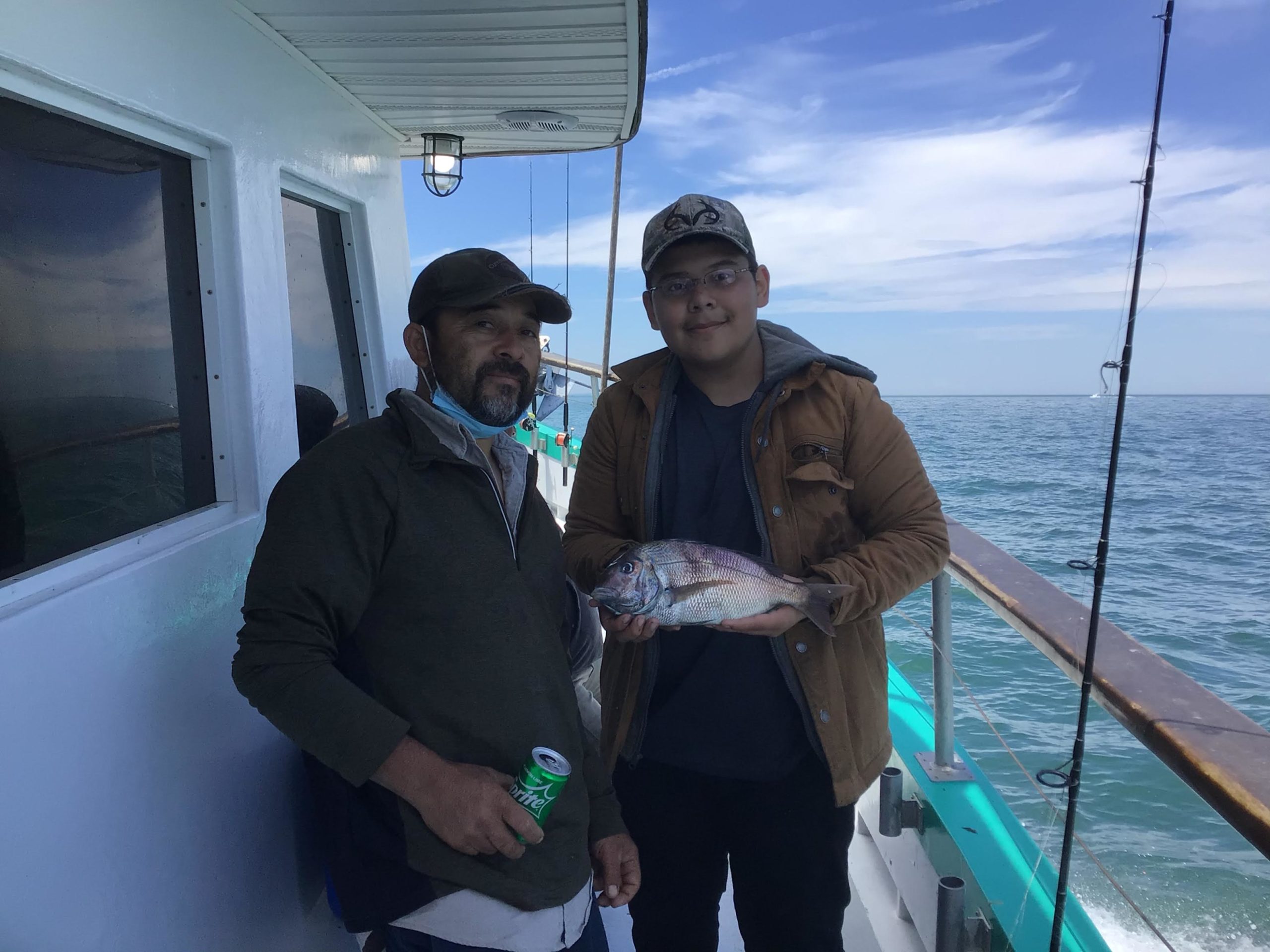 a person holding a fish in the water
