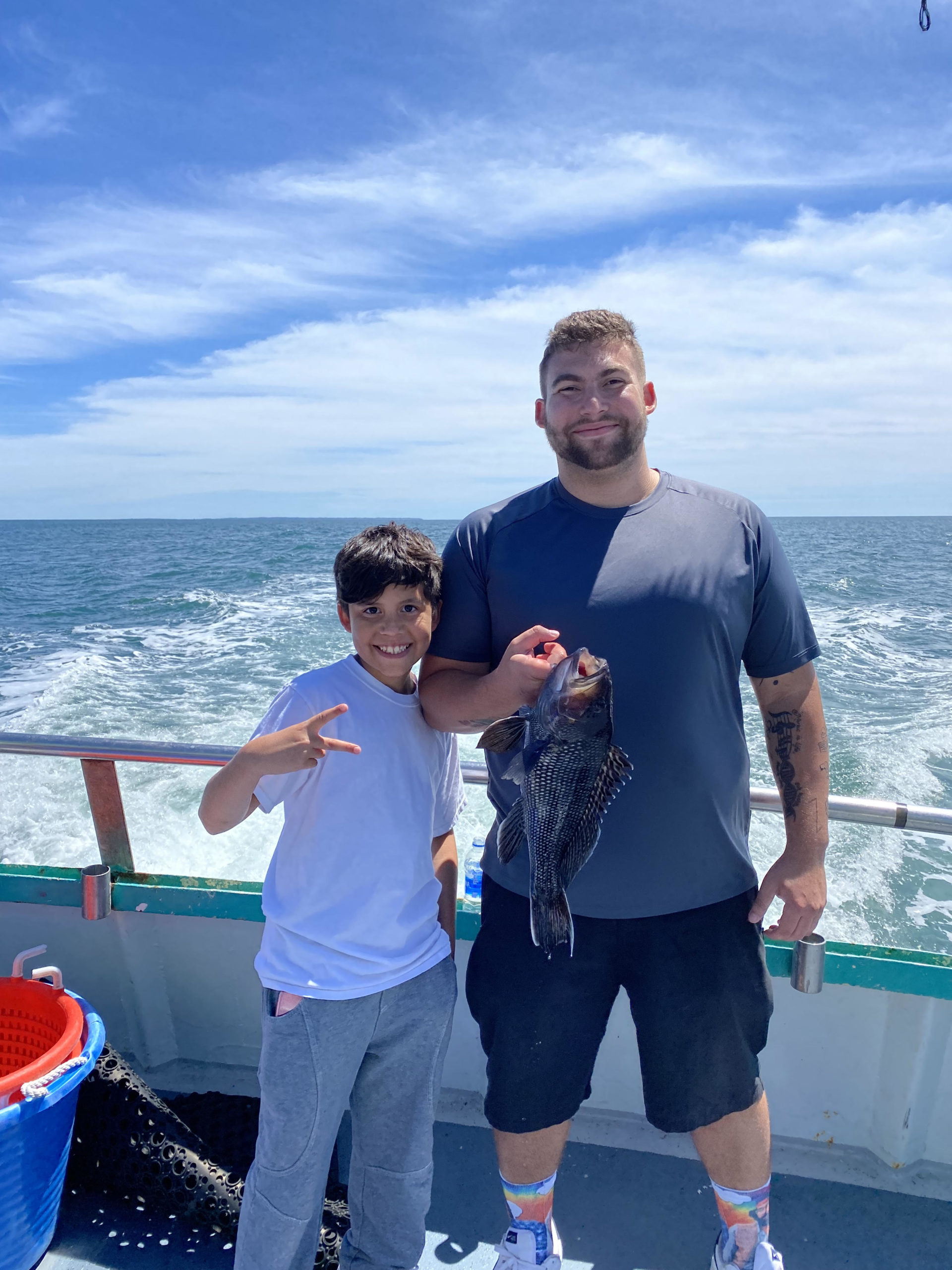 a man standing next to a body of water