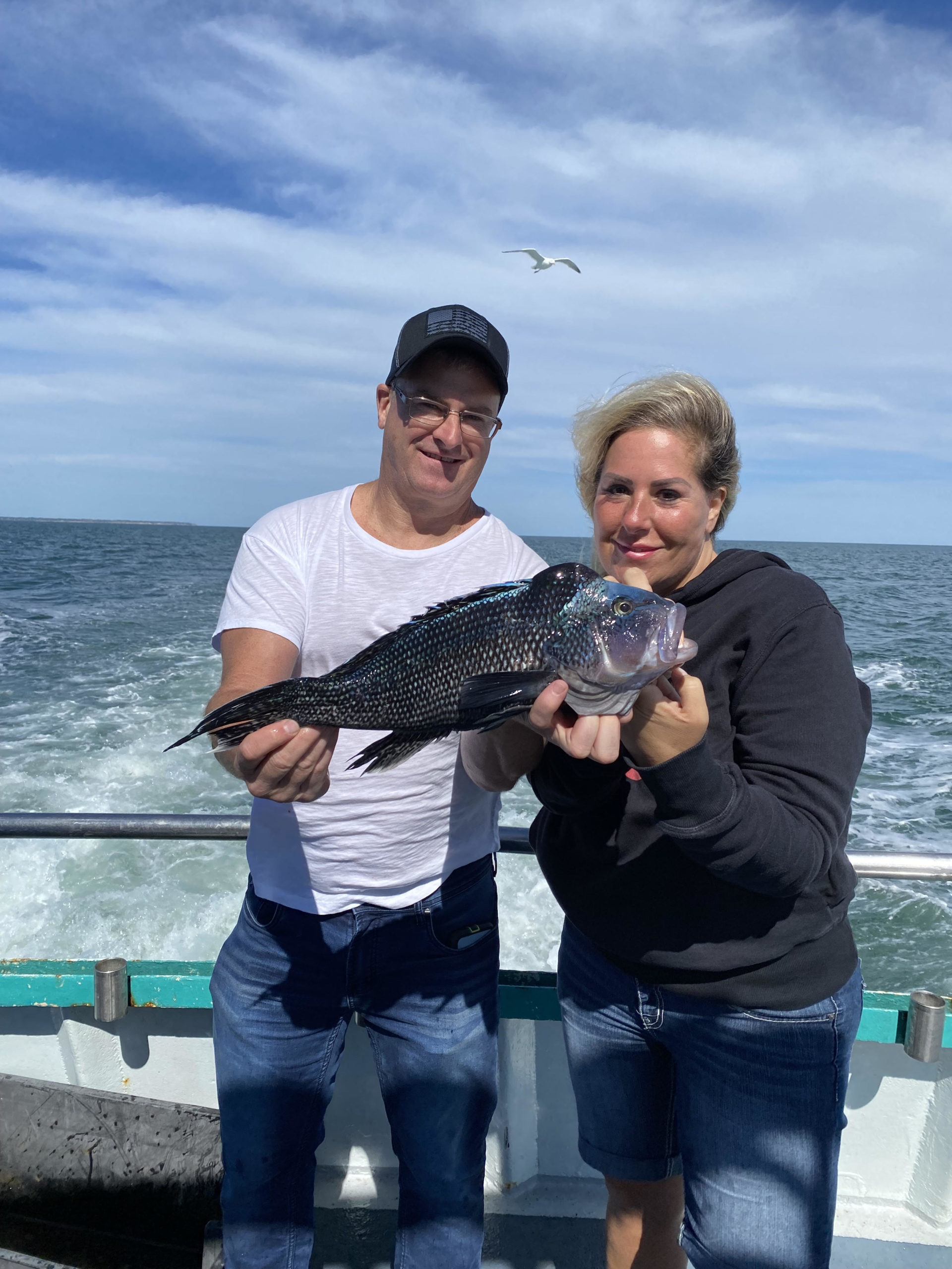 a person holding a fish in the water