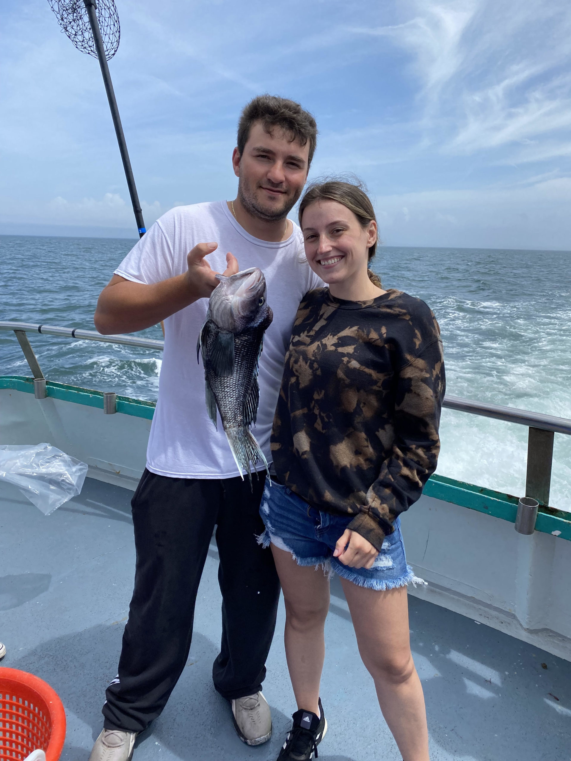 a man standing next to a body of water
