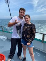 a man standing next to a body of water