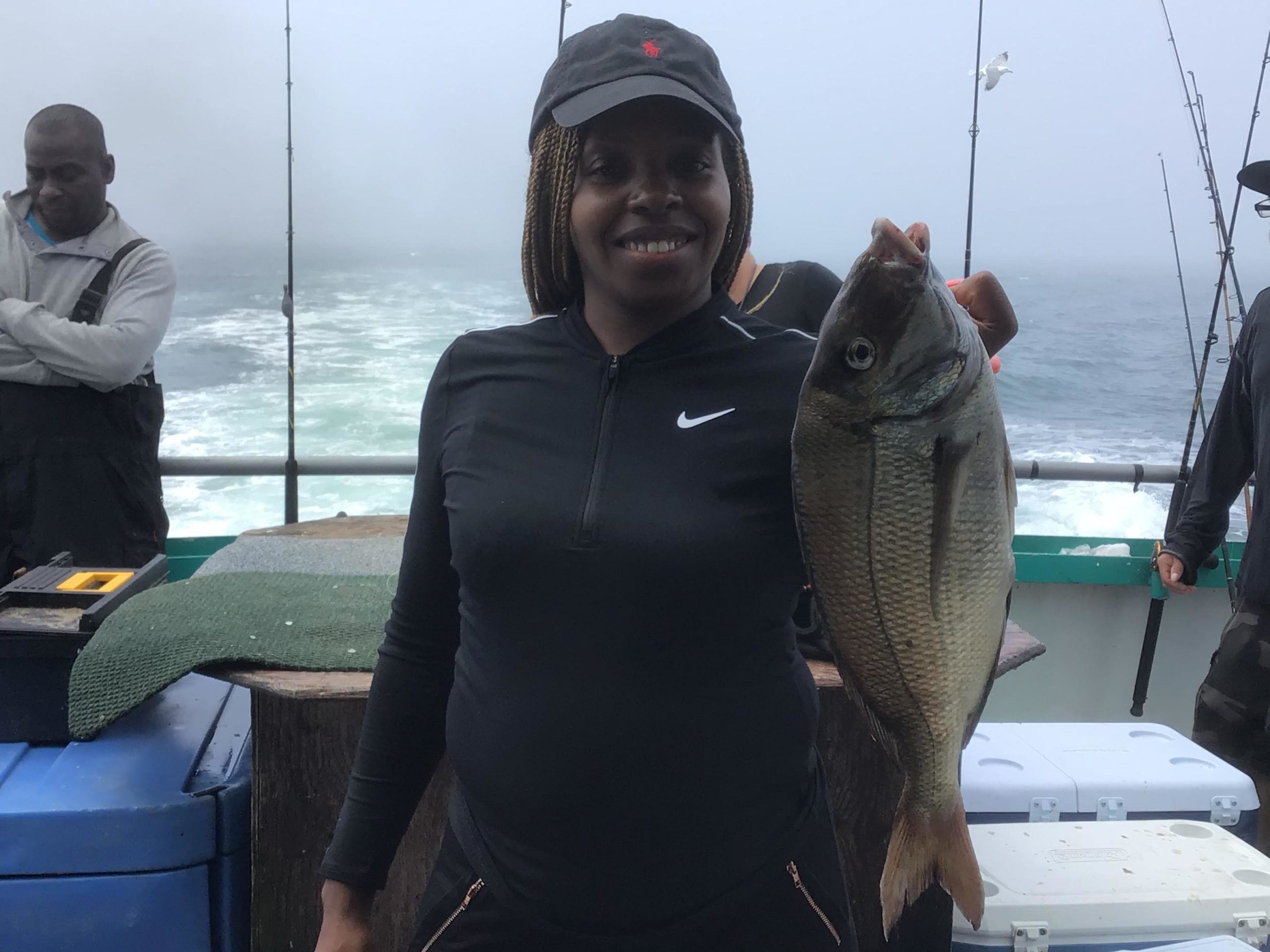a person holding a fish on a boat