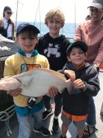 a young boy holding a fish