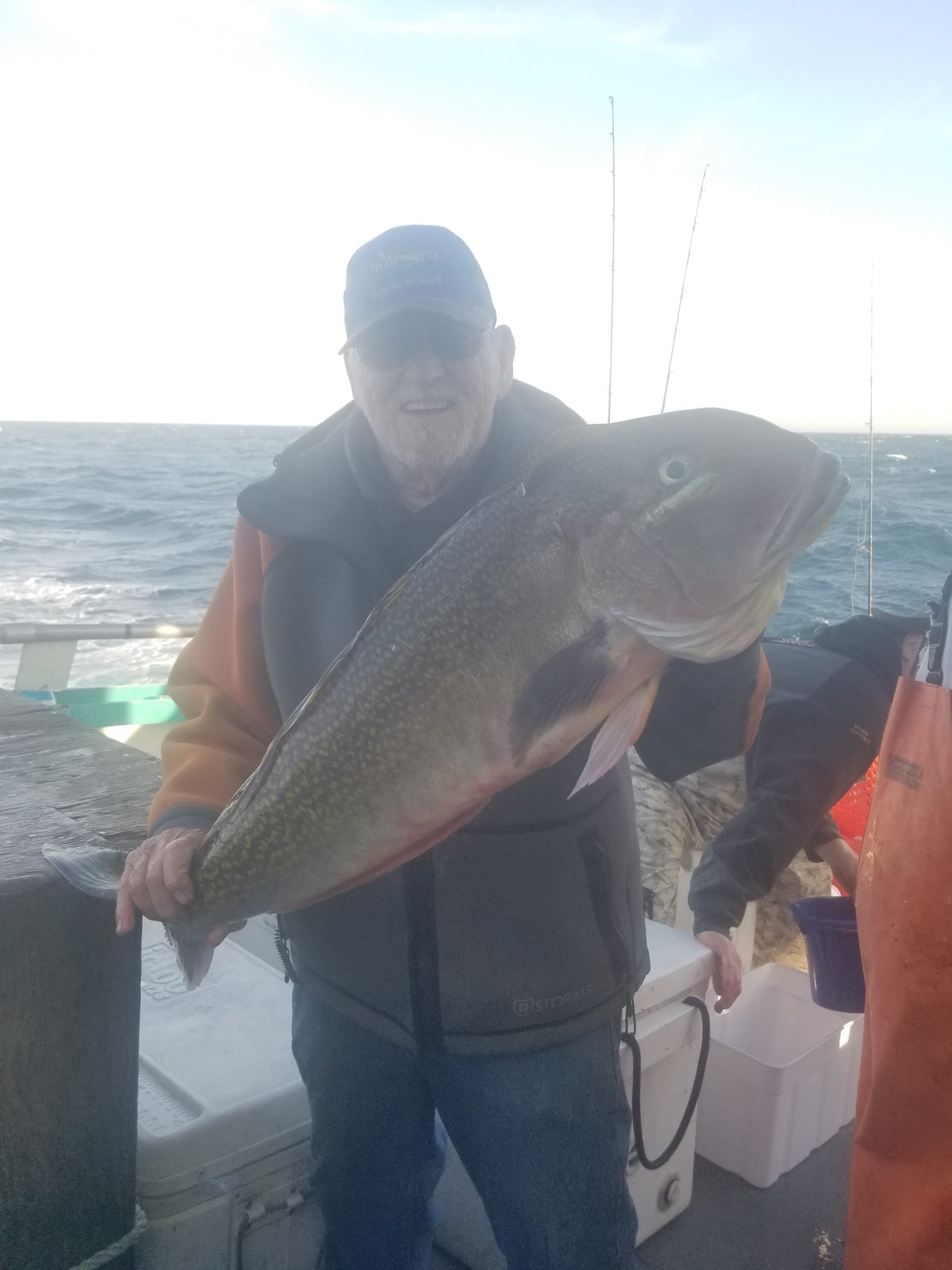 a man holding a fish in the water